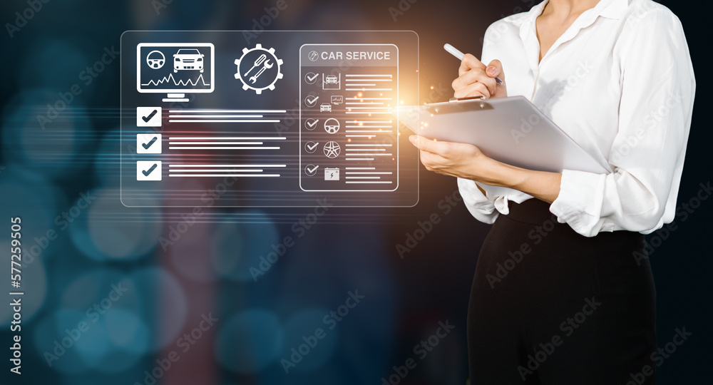 Female customer checking a list form of vehicle inspection and repair services Female customer checking a list form of vehicle inspection and repair services