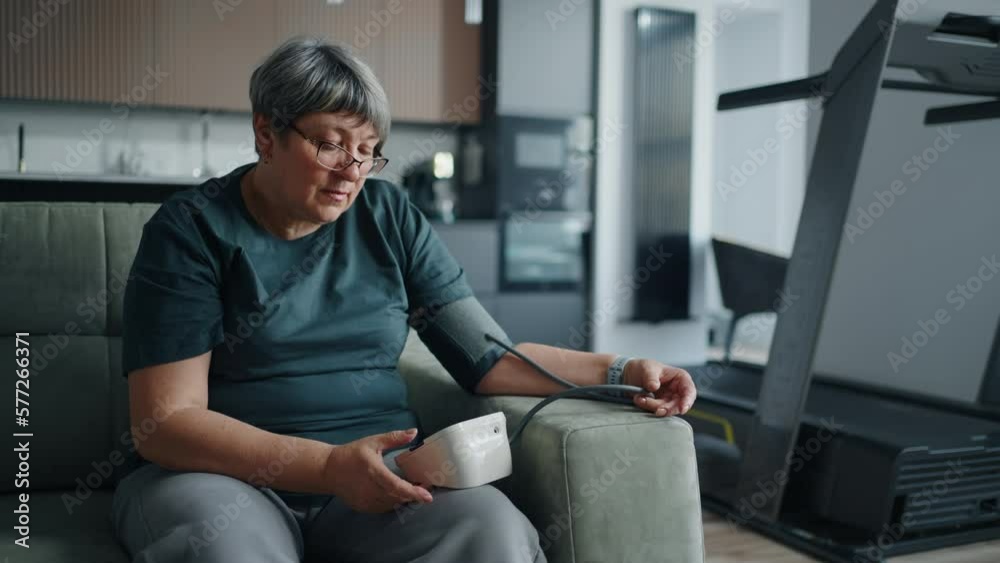 Grandmother Using Modern Electronic Sphygmomanometer At Home, Control Blood Pressure And Pulse Grandmother Using Modern Electronic Sphygmomanometer At Home, Control Blood Pressure And Pulse