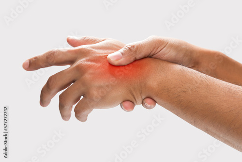 A man grab hand palm because the hand palm was injured. Hand pain. On a gray background. photo