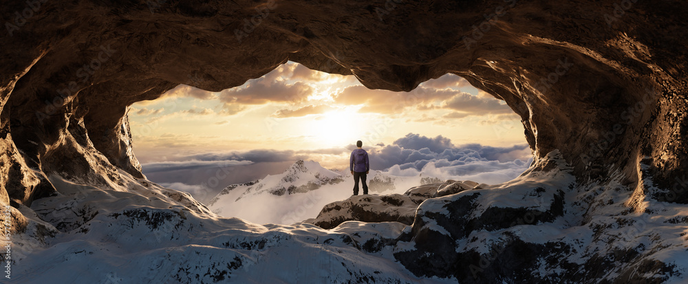 Adventurous Man Hiker standing in an Ice Cave with rocky mountains in background. Adventure Composite. Sunset Sky. 3d Rendering rocks. Aerial Image of landscape from British Columbia, Canada.