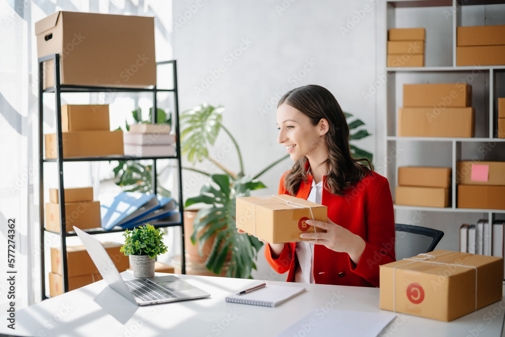 Startup small business SME, Entrepreneur owner woman using smartphone or tablet taking receive and checking online purchase shopping order Startup small business SME, Entrepreneur owner woman using smartphone or tablet taking receive and checking online purchase shopping order