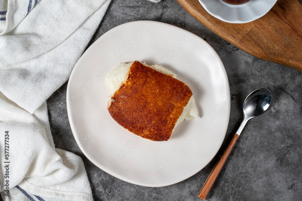 Milky dessert or Kazandibi. Traditional Turkish cuisine desserts. Kazandibi on a dark background. Top view Milky dessert or Kazandibi. Traditional Turkish cuisine desserts. Kazandibi on a dark background. Top view