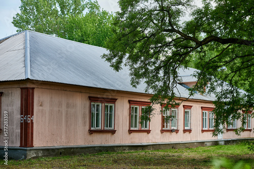 Wooden houses of Osiedle "Przyjaźń" in Warsaw surrounded by summer greenery