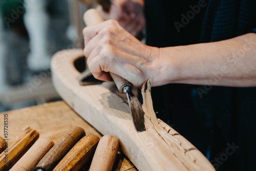 photographs of a woman engaged in hand-carving