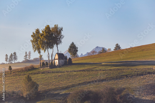 Landscape with a chapel and snow-covered Tatra Mountains in Kacwin, Malopolskie, Poland photo