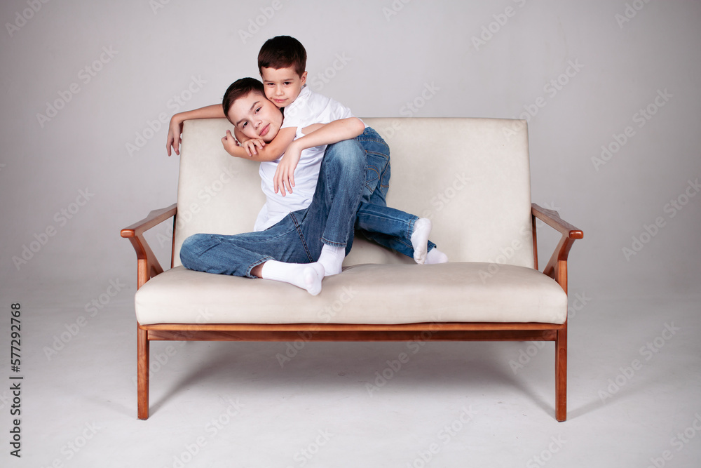 Obraz premium Two boys sitting together in studio