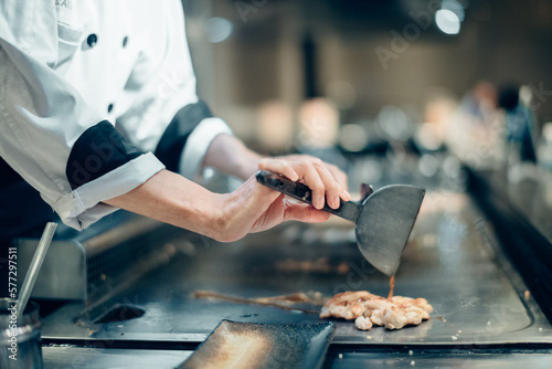 Hand of man take cooking of meat with vegetable grill, Chef cooking wagyu beef in Japanese teppanyaki restaurant