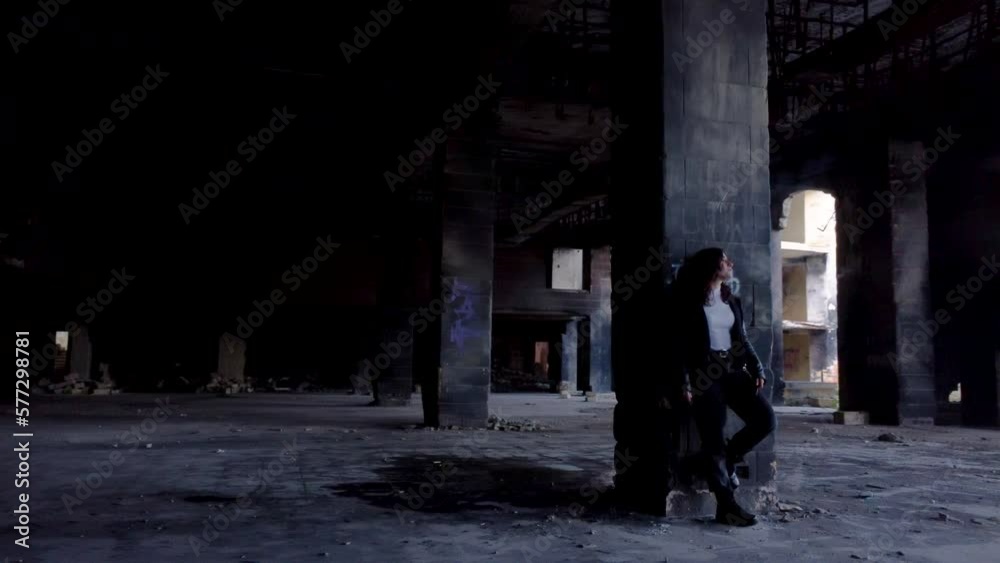 Drone round shot of a girl standing and smoking inside of abandoned Jerma Palace Hotel in Malta Drone round shot of a girl standing and smoking inside of abandoned Jerma Palace Hotel in Malta