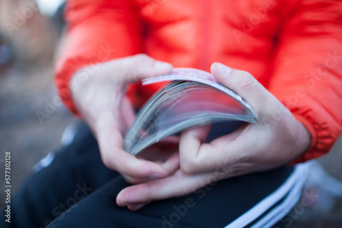 A man shuffles a deck of playing cards.
