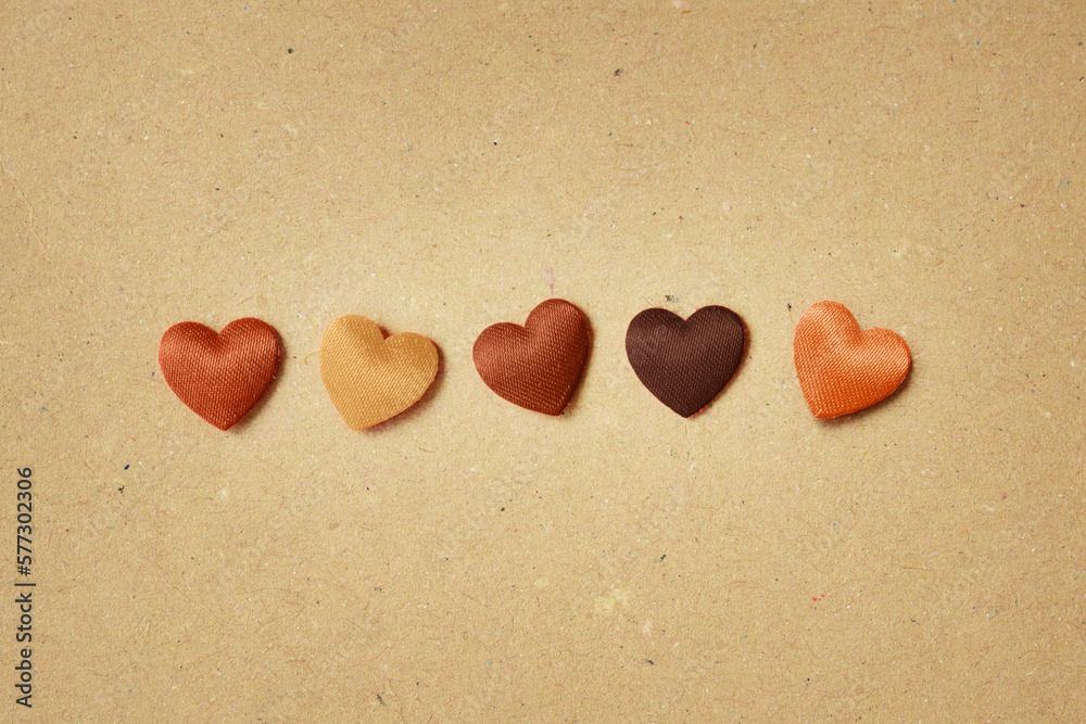 Hearts in skin colors on recycled paper background - Stop racism concept Hearts in skin colors on recycled paper background - Stop racism concept