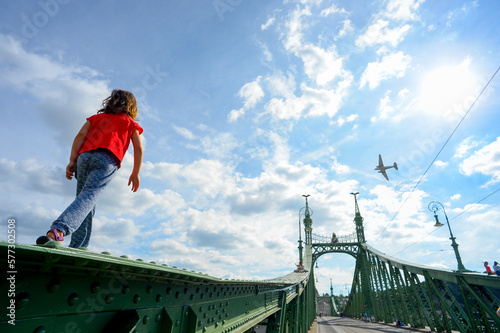 Girl walking on girder of Liberty Bridge on Danube River
