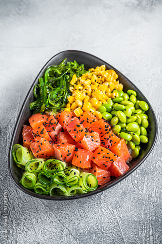 Salmon Poke bowl with Cucumber, Edamame, and Rice. White background. Top view