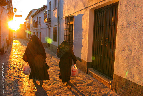 Nuns walking on street, Baeza, Andalusia, Spain photo