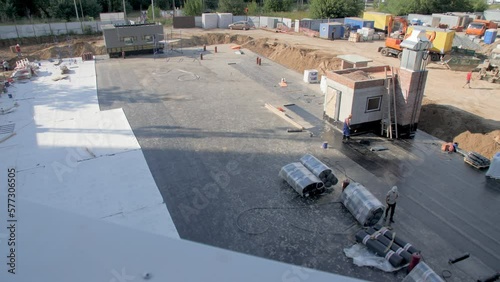 Ground with waterproof covering protection at building constriction site on sunny day. Technology of foundation installing