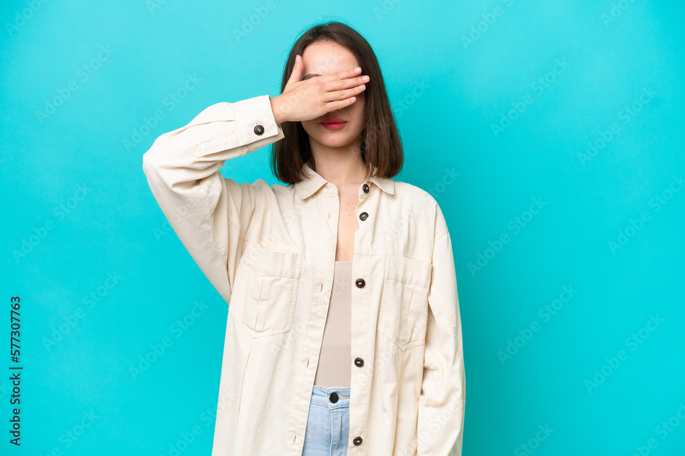 Young Ukrainian woman isolated on blue background covering eyes by hands. Do not want to see something Young Ukrainian woman isolated on blue background covering eyes by hands. Do not want to see something