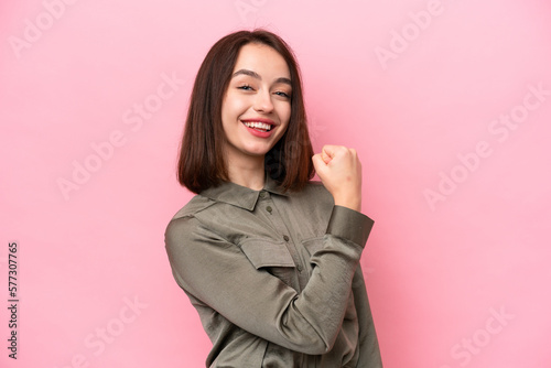Young Ukrainian woman isolated on pink background celebrating a victory © luismolinero