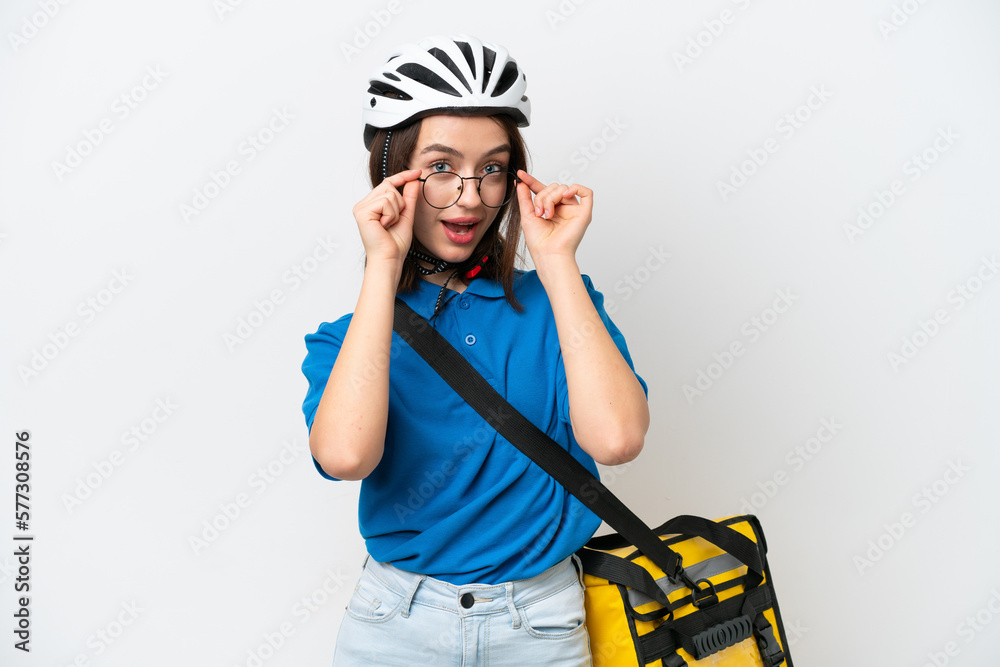 Young Ukrainian woman with thermal backpack isolated on white background with glasses and surprised Young Ukrainian woman with thermal backpack isolated on white background with glasses and surprised
