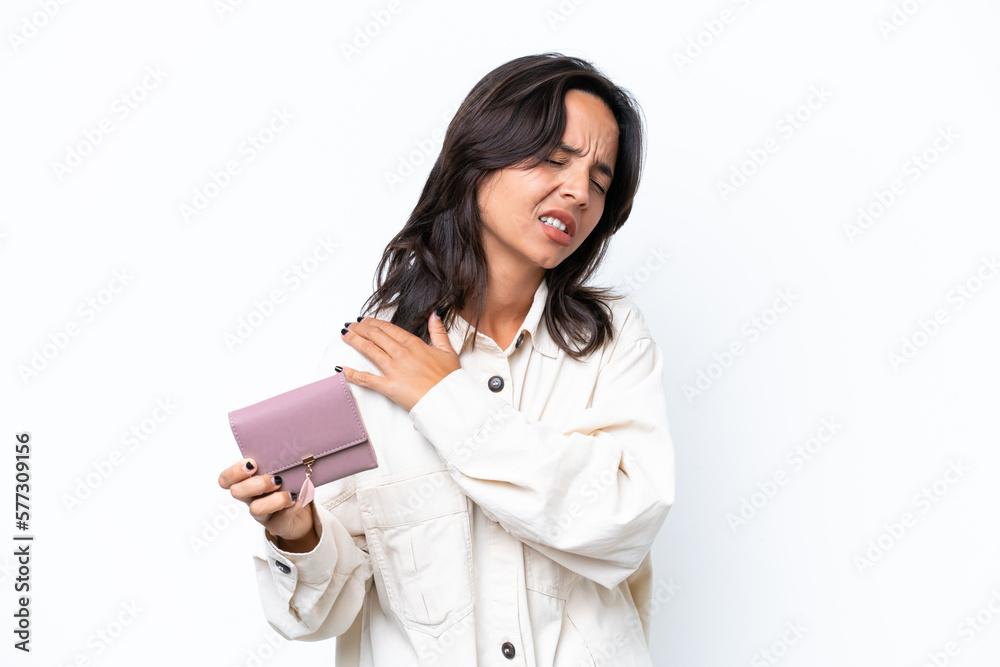 Young hispanic woman holding wallet isolated on white background suffering from pain in shoulder for having made an effort Young hispanic woman holding wallet isolated on white background suffering from pain in shoulder for having made an effort
