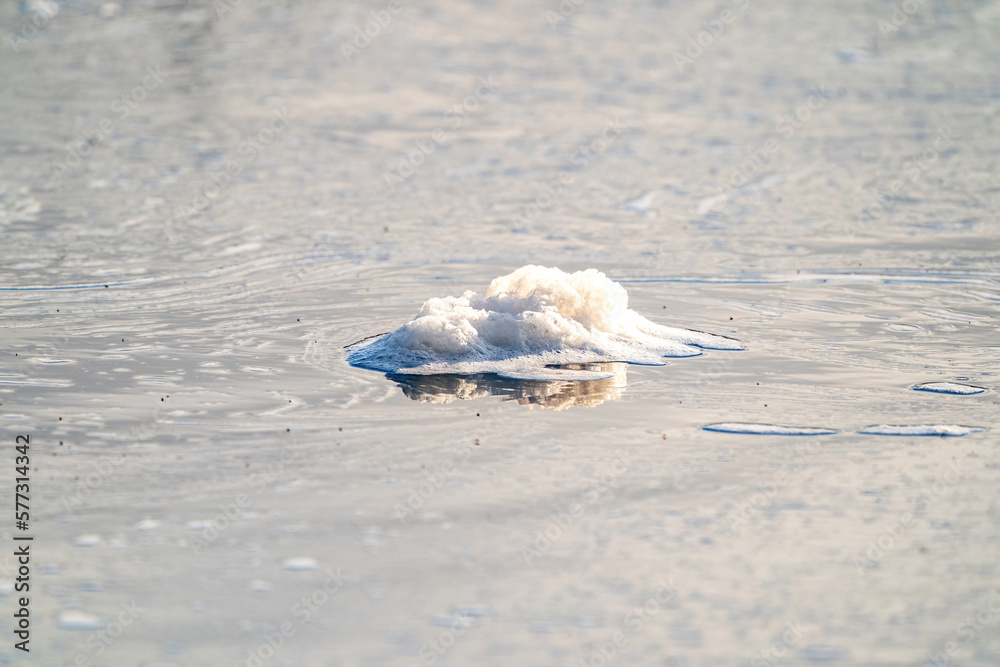Cold water and ice cubes melting under the sun background. Global warming or climate change concept. Cold therapy, breathing techniques, yoga and meditation