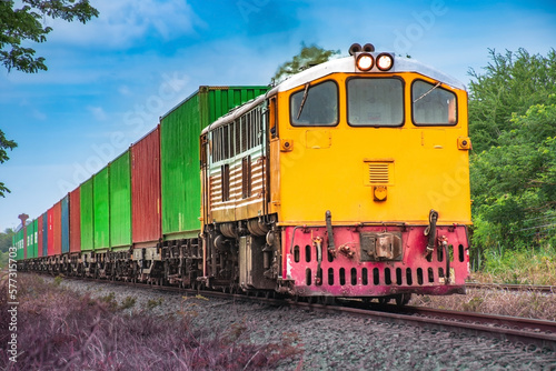 Container-freight train by diesel locomotive on the railway.