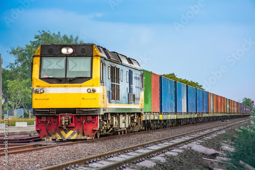 Container-freight train by diesel locomotive on the railway.