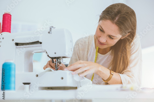 costume professional woman work enjoy with digital sewing machine happy in tailor studio
