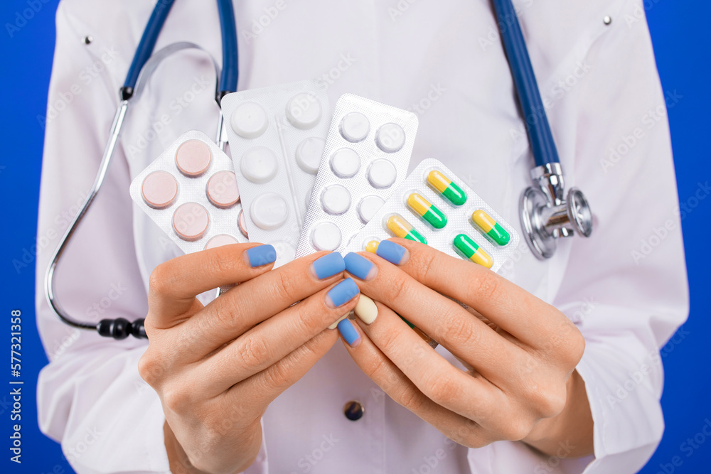 Close-up of a nurse's hands holding pills