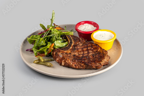 Wallpaper Mural Ribeye steak on a plate with salad and sauce Torontodigital.ca