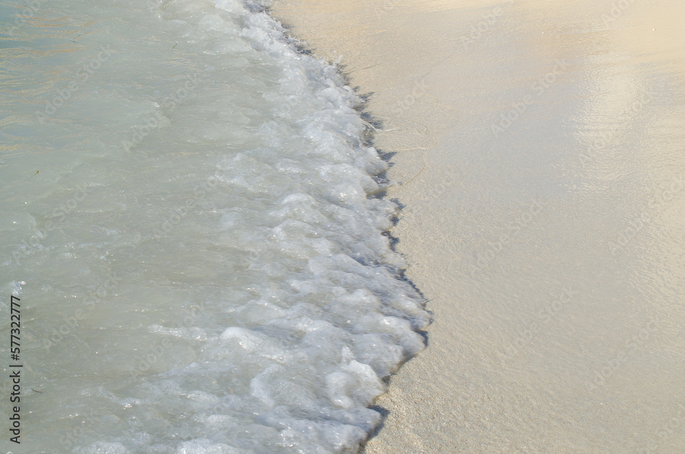 Calm beautiful wave on the white sand stock photo