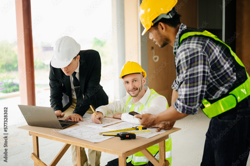 Architect caucasian man working with colleagues mixed race in the construction site. Architecture engineering on big project. Building in construction process . Architect caucasian man working with colleagues mixed race in the construction site. Architecture engineering on big project. Building in construction process .