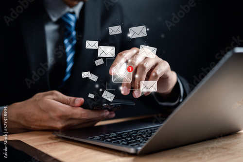 Businessman reading new email by laptop computer to customer, business contact and communication, email icon, email marketing concept, send e-mail or newsletter, online working internet network.