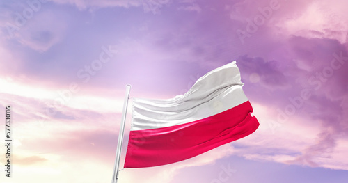 Waving Flag of Poland in Blue Sky. The symbol of the state on wavy cotton fabric.