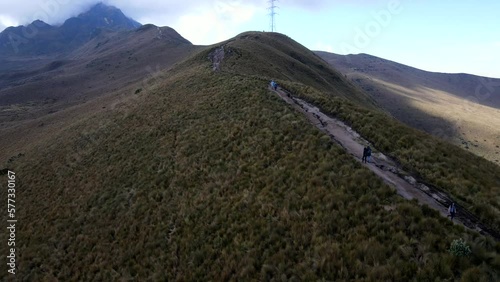 Aerial shot drone in wide shot over mountain hiking trail leading up to volcano
