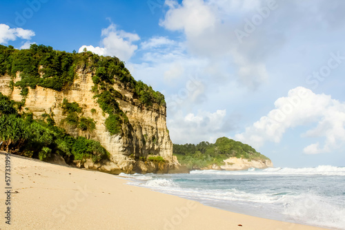 Tropical paradise beach with white sand and cliffs and blue sky with clouds on Sunny day. Summer tropical landscape, panoramic view. travel tourism wide panorama background concept. 