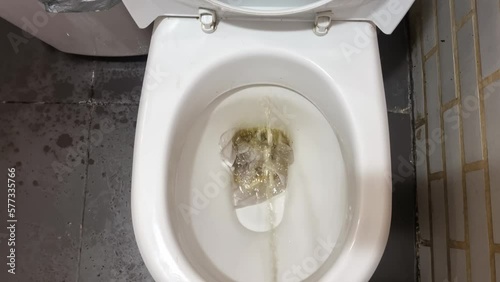 urine stream in toilet clogging with napkins and paper. clogging in the plumbing due to improper operation. photo