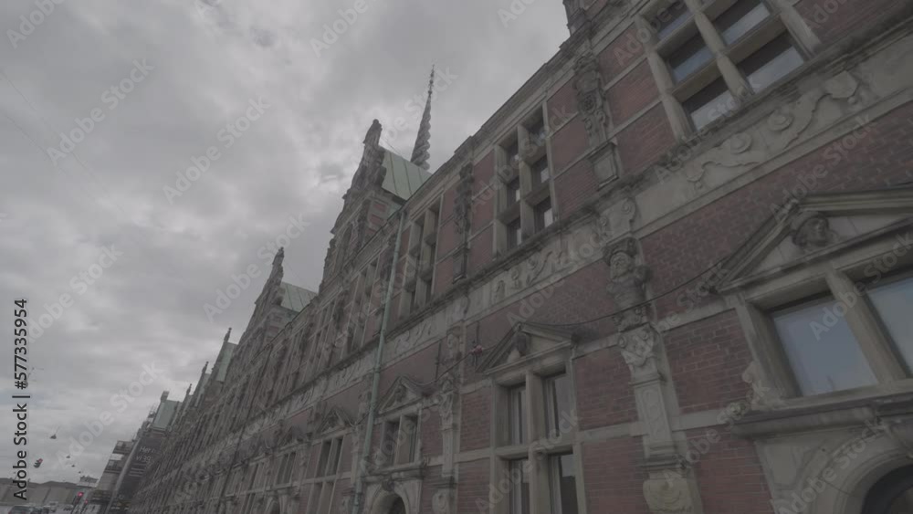 Shot of the Borson building in Copenhagen filmed from below on a cloudy day LOG