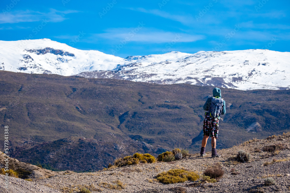 Female hiker hiking the mountains and valleys in the Sierra Nevada mountains in Spain