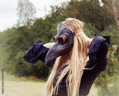 Photography Intriguing portrait of woman in plague mask with forest background