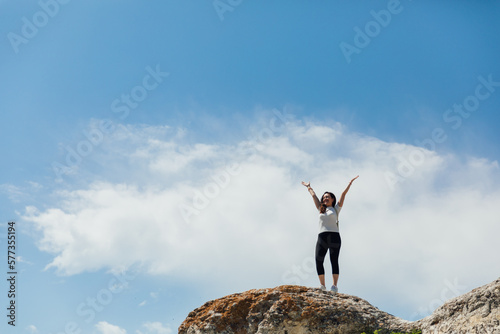woman in sportswear travel hiking on foot blue sky