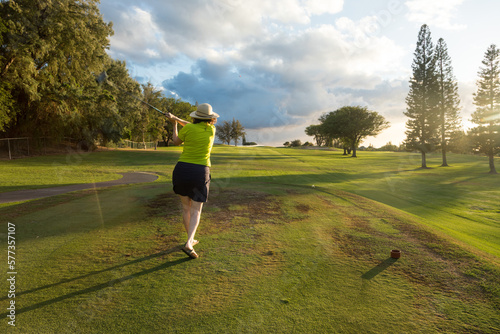 Woman Golfer Teeing Off on a Golf Course