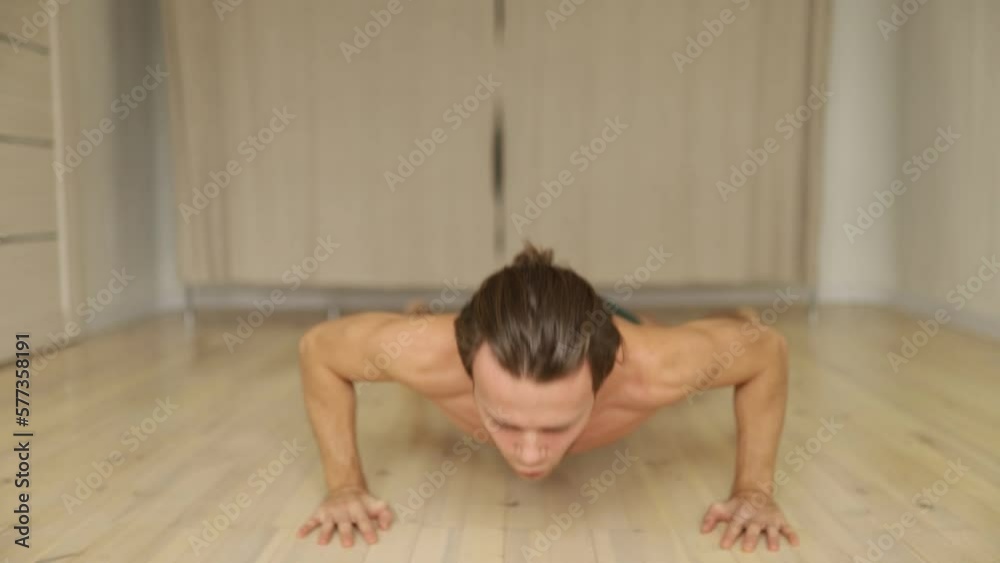 thin athletic man doing push-ups at home doing sports. thin athletic man doing push-ups at home doing sports.