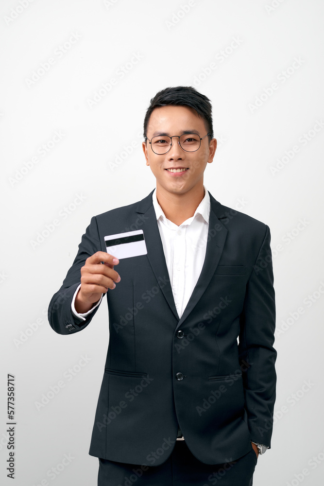 Portrait of handsome young businessman holding credit card over white background Portrait of handsome young businessman holding credit card over white background