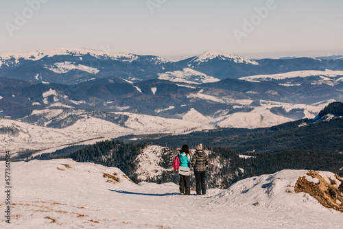 a group of people admire the snow-capped mountains