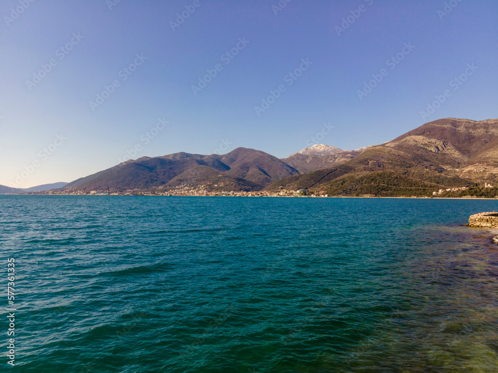 Montenegro, Balkans. View of the Adriatic Sea. Mountains are in the background. Blue sky, sunny day.