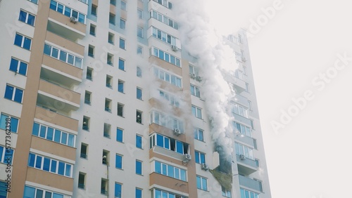 Kyiv, Ukraine - November 15, 2022: Fire in an apartment building, firefighters fighting the flames, burning house, fire disaster and accident tragedy concept.