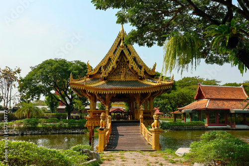 Chinese architecture of pavilion with corridor bridge in the pond with tree and blue sky background in park at Ancient City,Siam,Samutprakan province, Thailand.
 photo