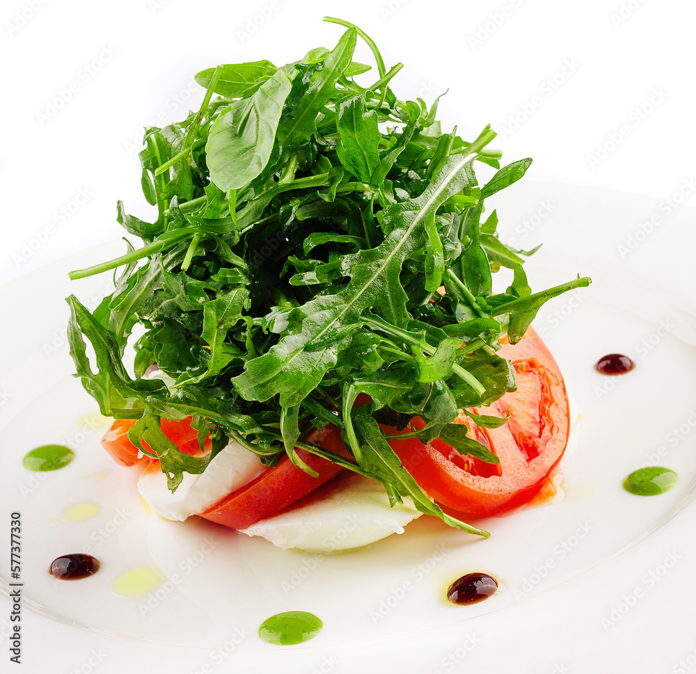 Green salad with arugula, tomato and feta cheese Green salad with arugula, tomato and feta cheese