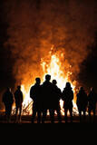 People silhouettes watching easter fire or bonfire. Vertical format with copy space. Generative AI.