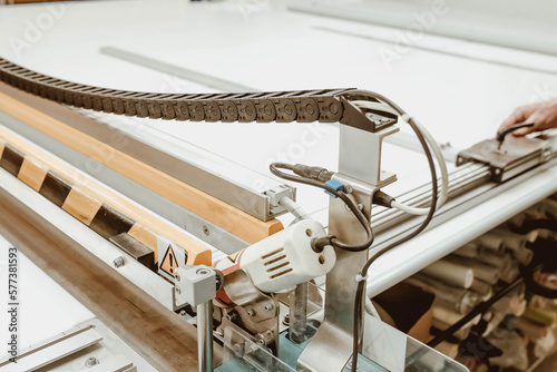Roller blind cutting machine. The process of creating blinds. Factory