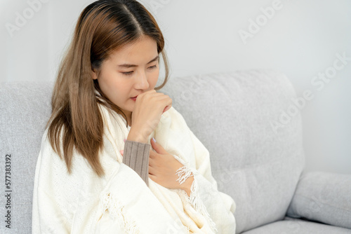 sick woman with a headache sitting under blanket, female sneezing and runny nose with seasonal influenza, allergic, high fever and influenza, resting, virus, coronavirus, feel illness, respiratory